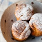three of our rhubarb and custard cruffins in a bowl with a delicate dust of icing sugar