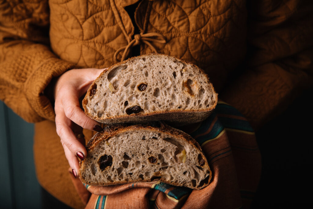 Holding sourdough loaf Lovingly Artisan Kendal Cumbria artisan bakery