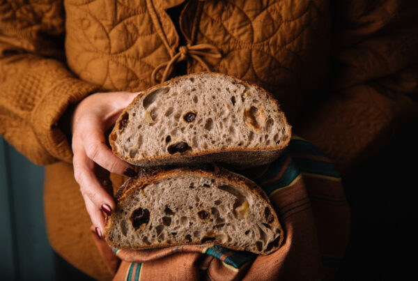 Holding sourdough loaf Lovingly Artisan Kendal Cumbria artisan bakery
